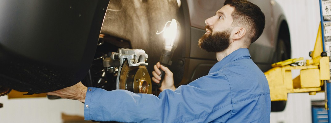 A stock photo of a person fixing brakes.